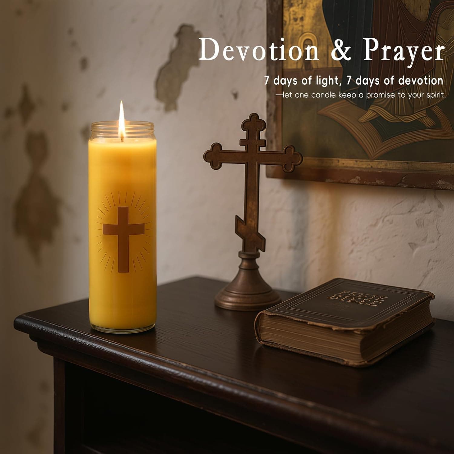 An Anovia 7-day devotional candle beside a brass cross and an old Bible